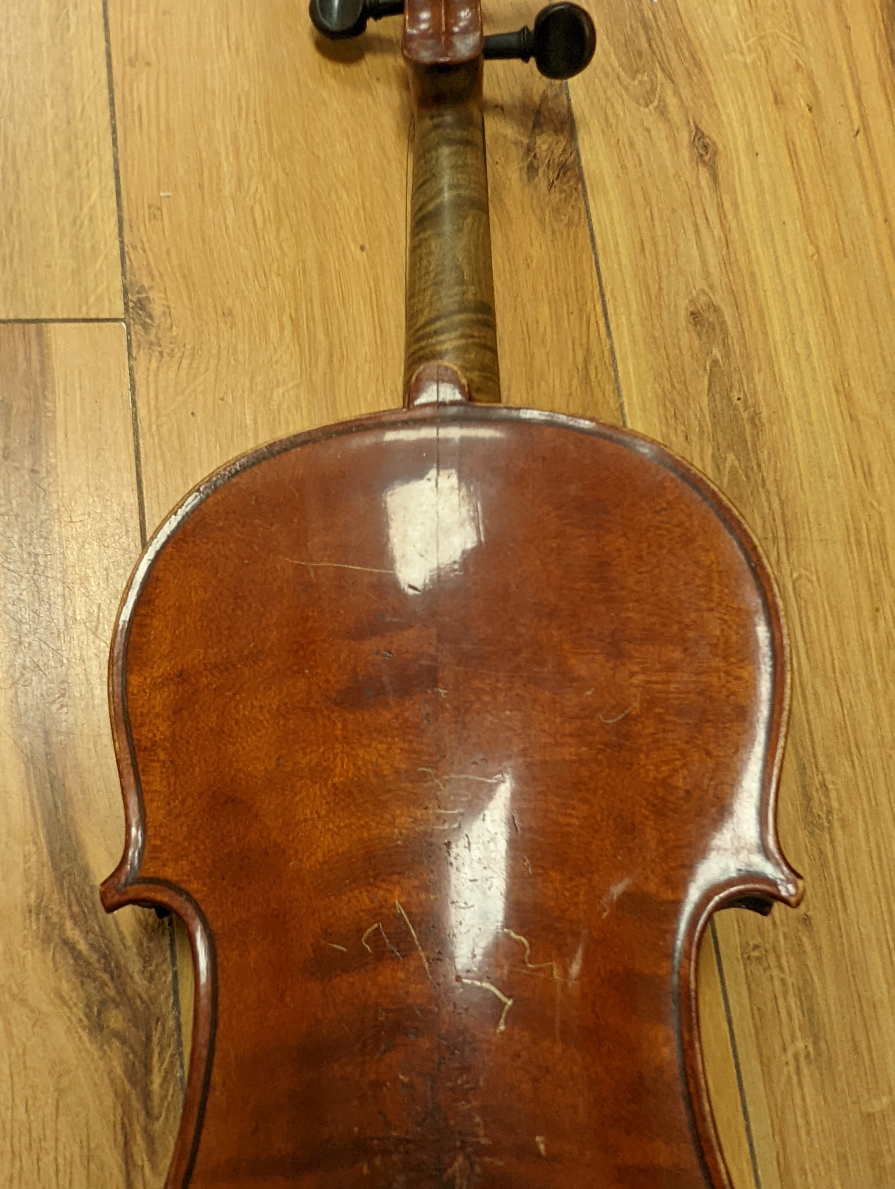 An early 20th century French vioilin, cased with bow and a cased saxon violin